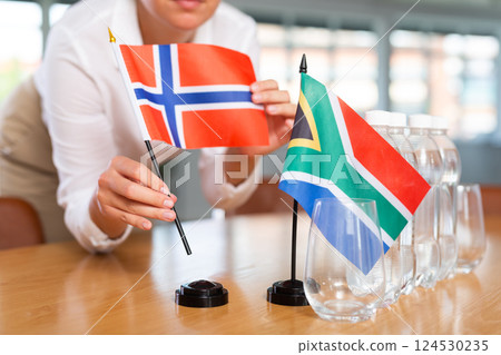 Blurry girl set midget flags of South Africa and Norway before international negotiations Blurry girl set midget flags of South Africa and Norway before international negotiations 124530235