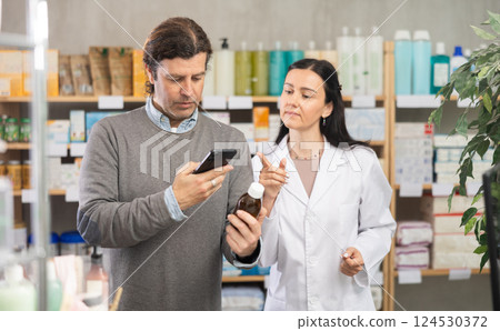 Man scanning cough syrup at pharmacy 124530372