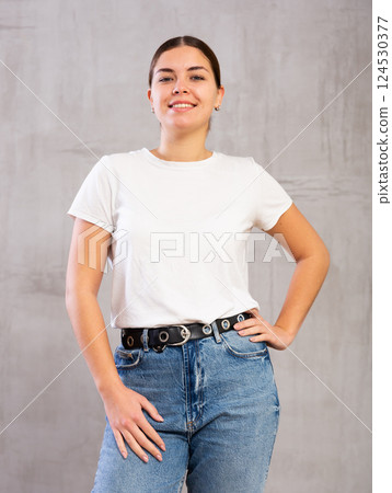 Smiling young woman posing in casual clothes 124530377