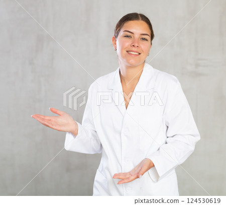 Young woman posing in medical uniform in studio Young woman posing in medical uniform in studio 124530619