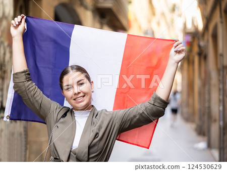 Young smiling woman holding France flag 124530629