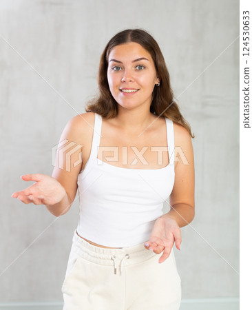Young woman in casual clothes posing in studio Young woman in casual clothes posing in studio 124530633