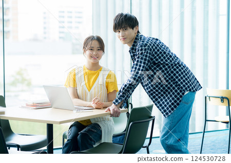 Students talking while looking at a computer 124530728
