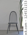 A grey chair on a bare concrete floor 124531153