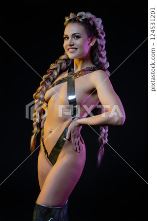 Woman with silver tape body art poses confidently in elegant lingerie Woman with silver tape body art poses confidently in elegant lingerie 124531201