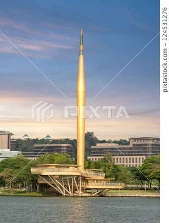 Millennium Monument in Putrajaya, Malaysia reflects in a lake during a serene sunset sky 124531276