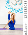 Young woman practicing an advanced yoga pose indoors 124532035