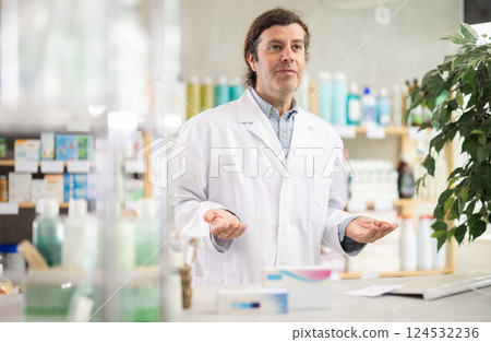 Man pharmacy employee works with computer and notebook dairy. 124532236
