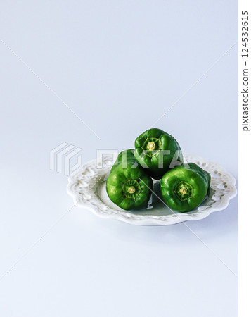 Three peppers on a plate 124532615