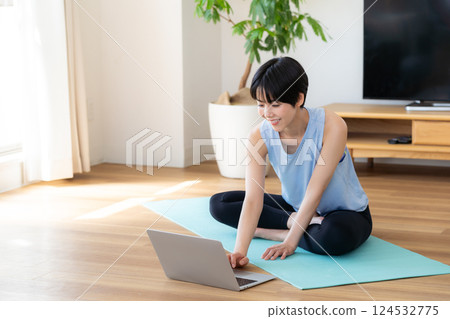 Woman doing yoga in the living room Woman doing yoga in the living room 124532775
