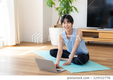 Woman doing yoga in the living room 124532776