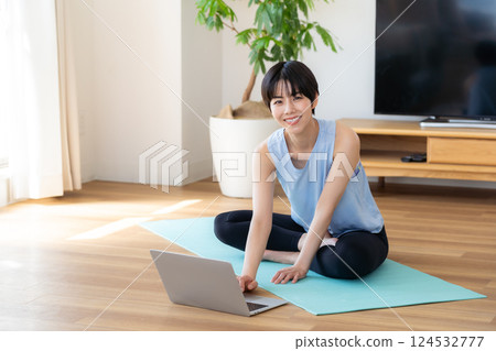 Woman doing yoga in the living room 124532777