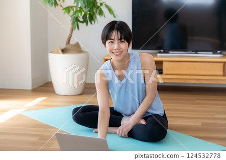 Woman doing yoga in the living room 124532778