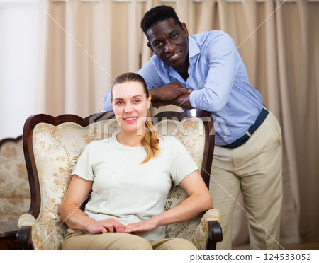 Portrait of happy couple on luxurious sofa in room 124533052