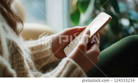 Woman's hands operating a smartphone 124533214