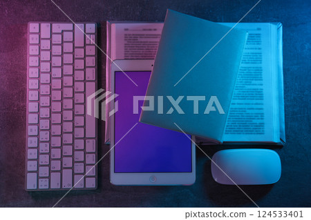 Books with a tablet and a keyboard, on a light background. Books with a tablet and a keyboard, on a light background. 124533401