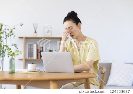 A woman watching a personal computer in the living room 124533687