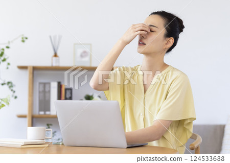 A woman watching a personal computer in the living room A woman watching a personal computer in the living room 124533688