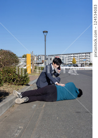 A man rescuing a fallen man 124534083