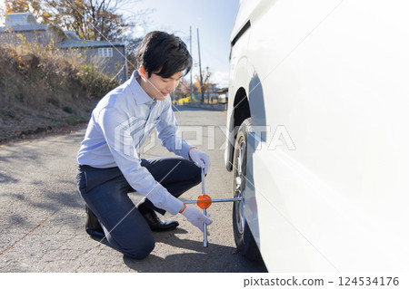 Changing car tires, flat tires, changing tires Changing car tires, flat tires, changing tires 124534176