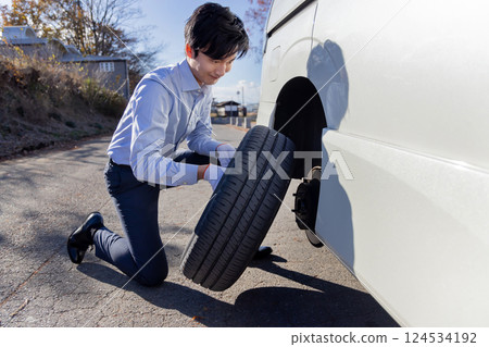 Changing car tires, flat tires, changing tires Changing car tires, flat tires, changing tires 124534192