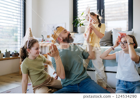 Portrait of father with three daughters at home. Portrait of father with three daughters at home. 124534290