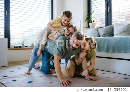 Portrait of father with three daughters at home. Portrait of father with three daughters at home. 124534291