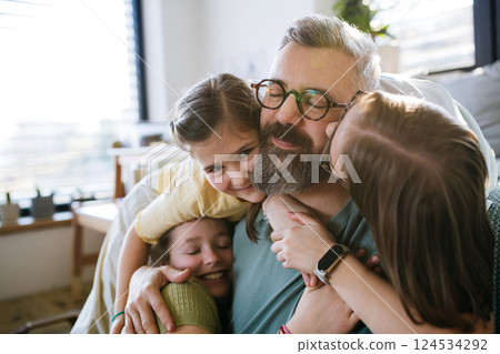 Portrait of father with three daughters at home. Portrait of father with three daughters at home. 124534292
