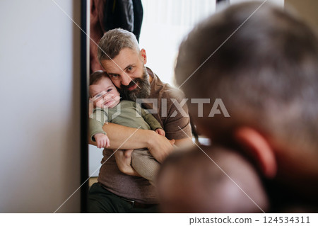 Father comforting his crying baby son. Father comforting his crying baby son. 124534311