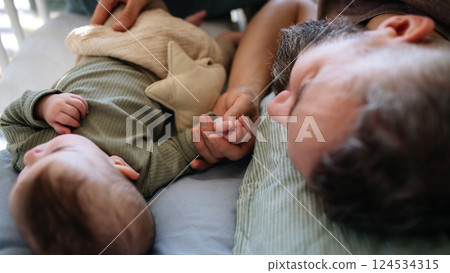 Father cosleeping with baby boy. 124534315