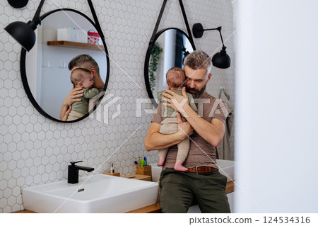 Father comforting his crying baby son. 124534316