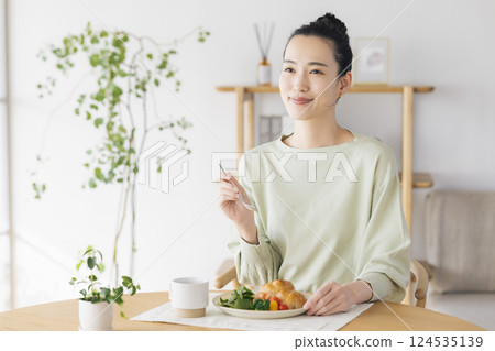 woman eating at home woman eating at home 124535139
