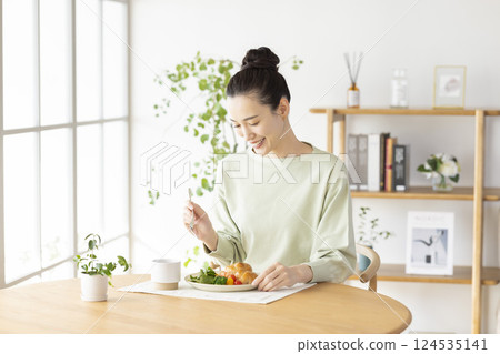 woman eating at home woman eating at home 124535141