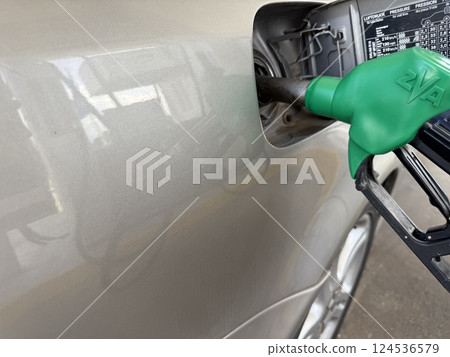 Car refueling on a petrol station. Closeup photography of a car and a gas station. Car refueling on a petrol station. Closeup photography of a car and a gas station. 124536579