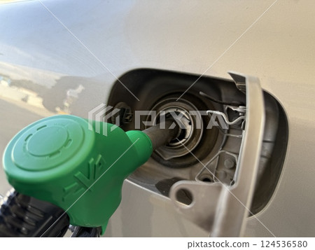 Car refueling on a petrol station. Closeup photography of a car and a gas station. Car refueling on a petrol station. Closeup photography of a car and a gas station. 124536580