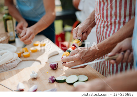 Close up of family preparing food for a spring weekend barbecue. 124536692