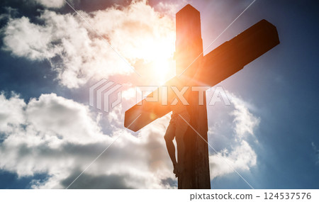 Crucifixion of Christ against the sky background. Catholicism, Christianity, faith concept. Crucifixion of Christ against the sky background. Catholicism, Christianity, faith concept. 124537576