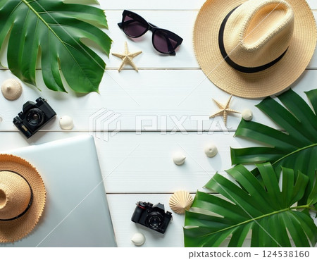 Summer vacation travel essentials with tropical vibes and retro cameras 124538160