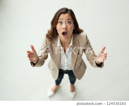 Surprised woman in business attire expressing enthusiasm and shock 124538163