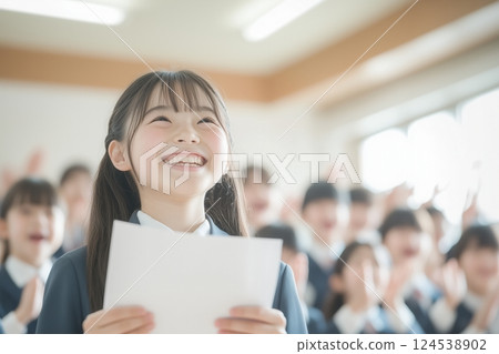 The award ceremony with a proud and shining smile in front of classmates 124538902