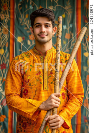 Portrait of Indian man in ethnic attire with dandiya sticks 124538971