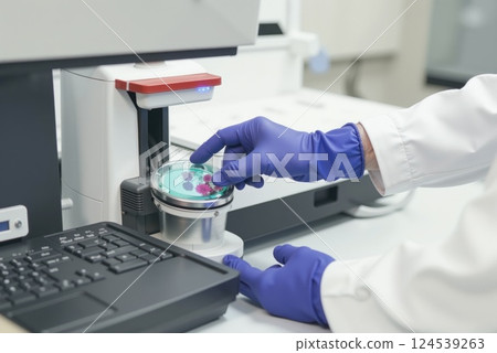 Scientist analyzing microorganisms with electron microscope for biomedical research 124539263