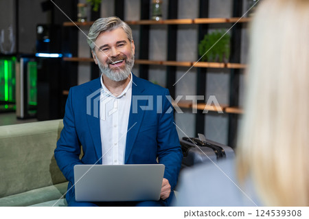 Mature business man having an interview with a work candidate and looking involved 124539308