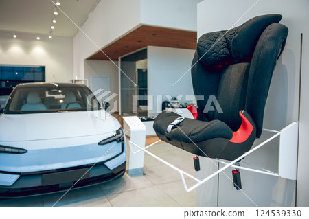 Baby seat on display in car dealership 124539330