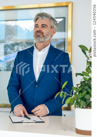 Entrepreneur in modern office presenting digital data on large screen Entrepreneur in modern office presenting digital data on large screen 124540356