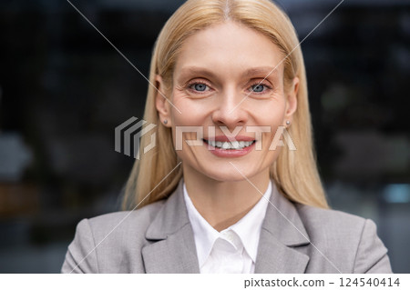 Headshot of a blonde cute caucasian smiling woman 124540414