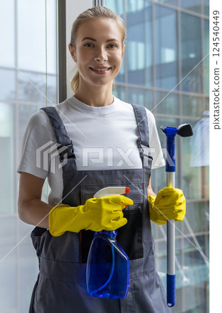 Female cleaner standing with the window washer in her hands 124540449