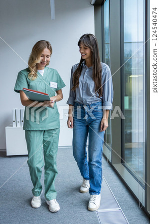 Physician in medical office talking with patient during consultation discussing diagnosis Physician in medical office talking with patient during consultation discussing diagnosis 124540474