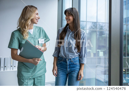 Male specialist holding file and documents discussing treatment with woman patient Male specialist holding file and documents discussing treatment with woman patient 124540476