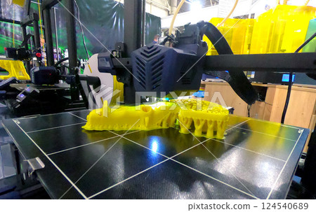 The process of printing on a 3D printer. 3D printer printing object from molten plastic close-up. Creative creation of model on 3D printer. New modern technologies of 3D printing. Additive technology The process of printing on a 3D printer. 3D printer printing object from molten plastic close-up. Creative creation of model on 3D printer. New modern technologies of 3D printing. Additive technology 124540689